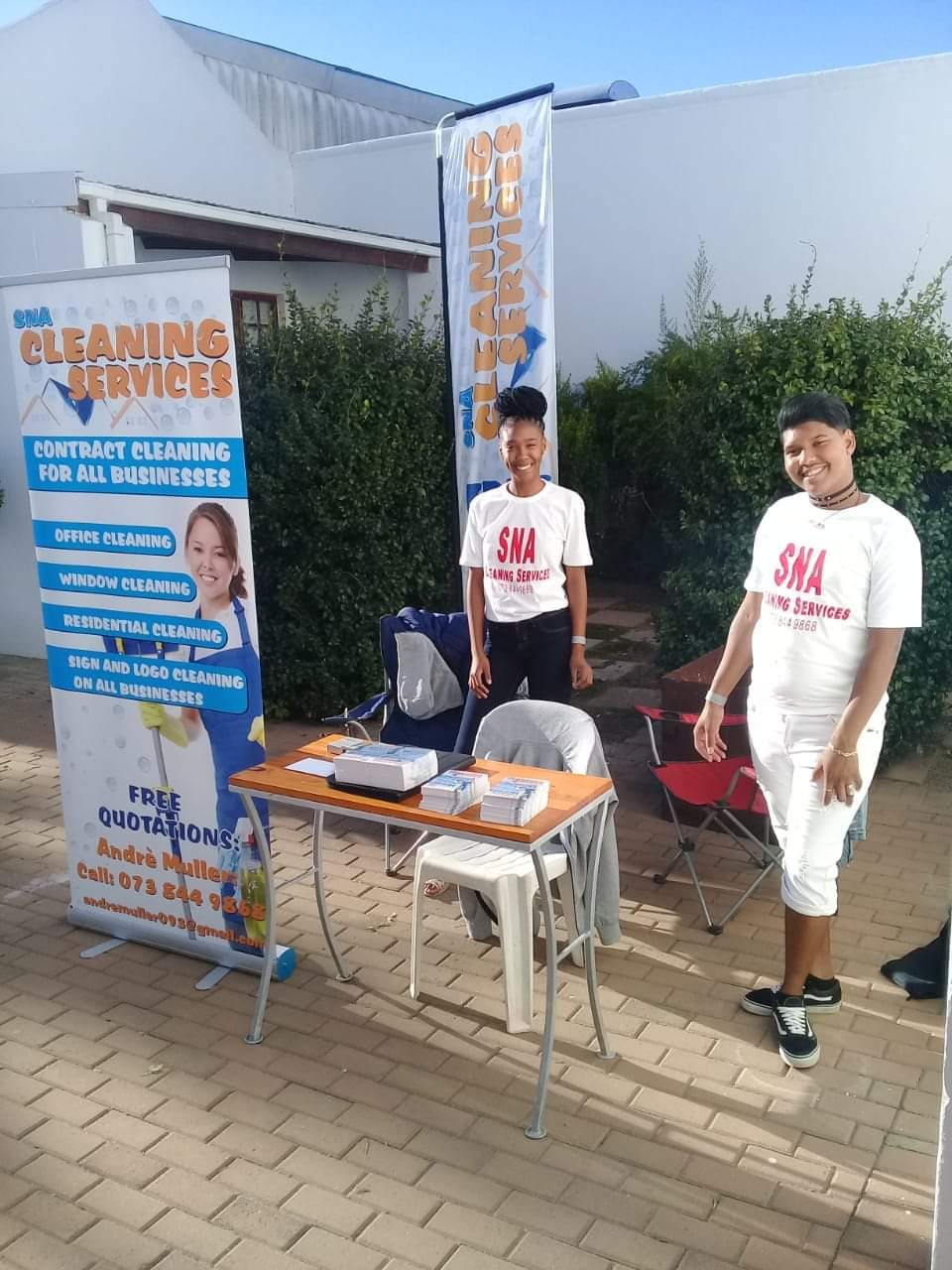 SNA staff at an outdoor promotional booth handing out quotes