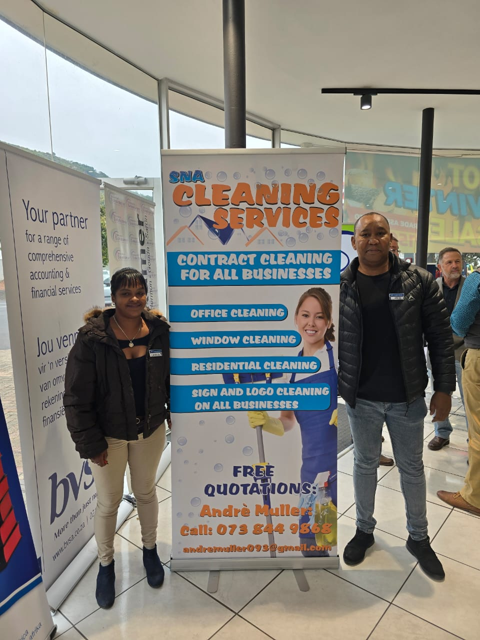 Andre Muller with SNA Cleaning Services staff at a promotional stand